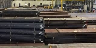 Stacked steel plates in a manufacturing warehouse for industrial and construction use