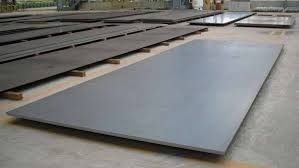 Large flat metal plates stacked in manufacturing facility for industrial use